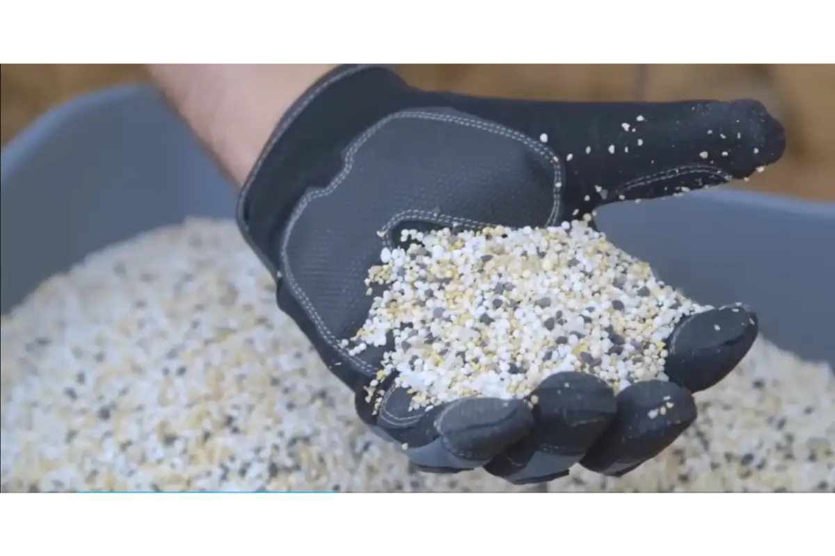 Professional lawn fertilizer spreader applying nutrients to grass